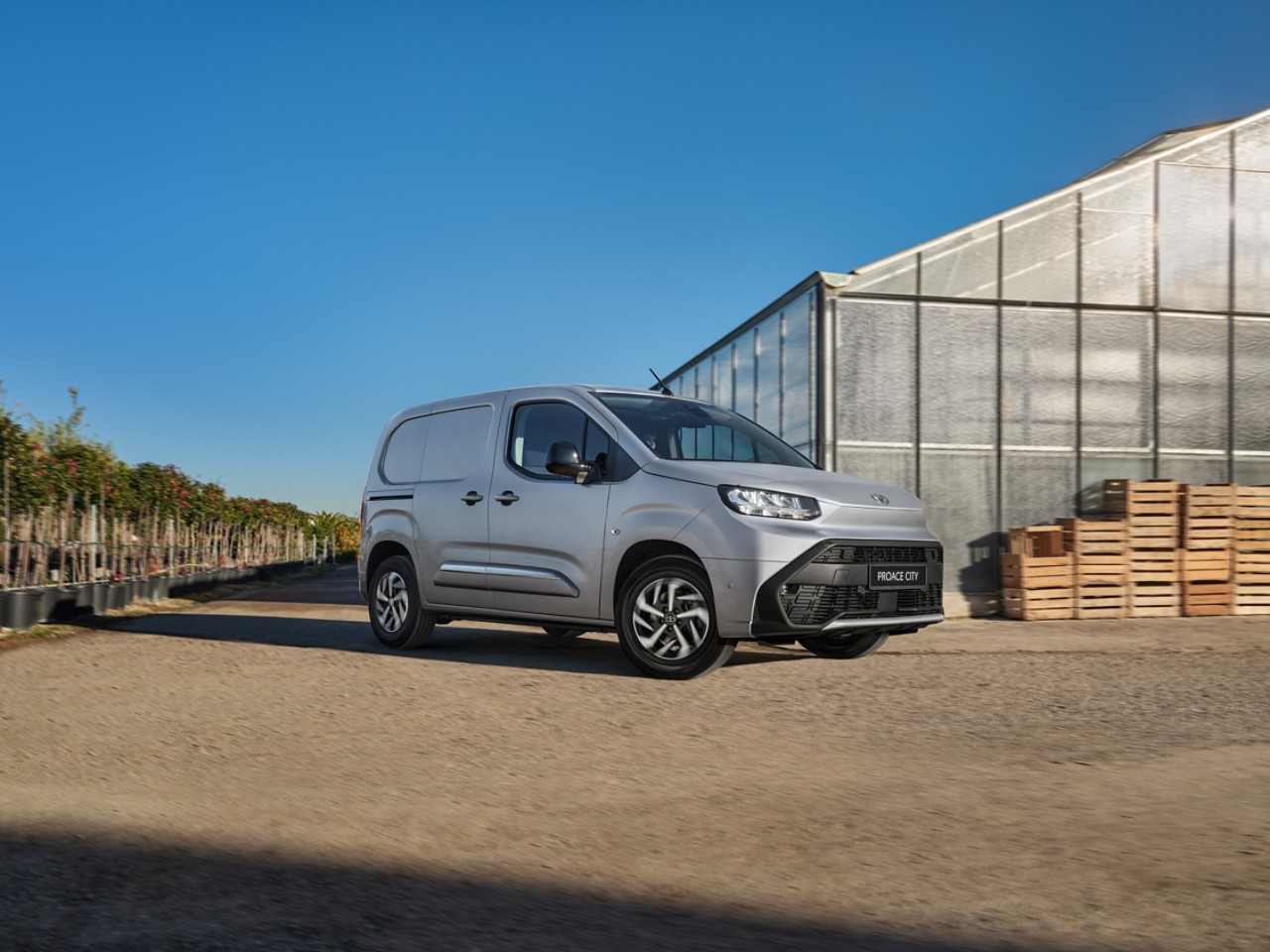 A Toyota Proace drives a long country road